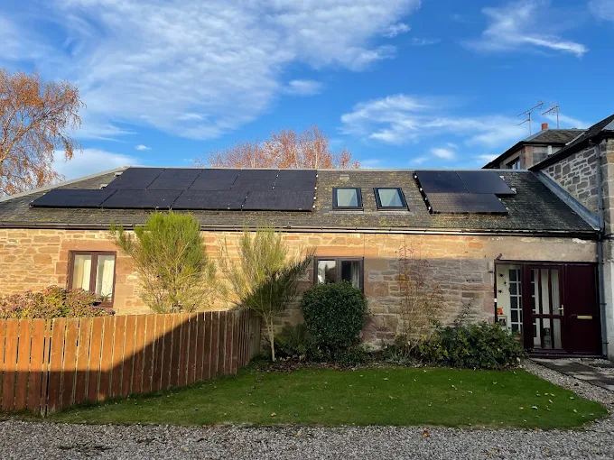 Scottish stone cottage with 22 JA Solar panels installed across the pitched slate roof, John Moisey install, October 2025