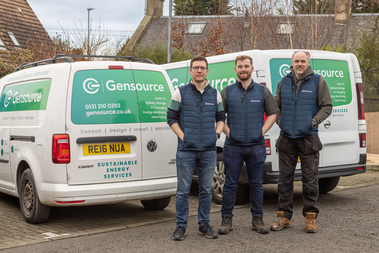 Three members of the Gensource in-house engineering team standing in front of branded Gensource vans in Newbridge, Edinburgh